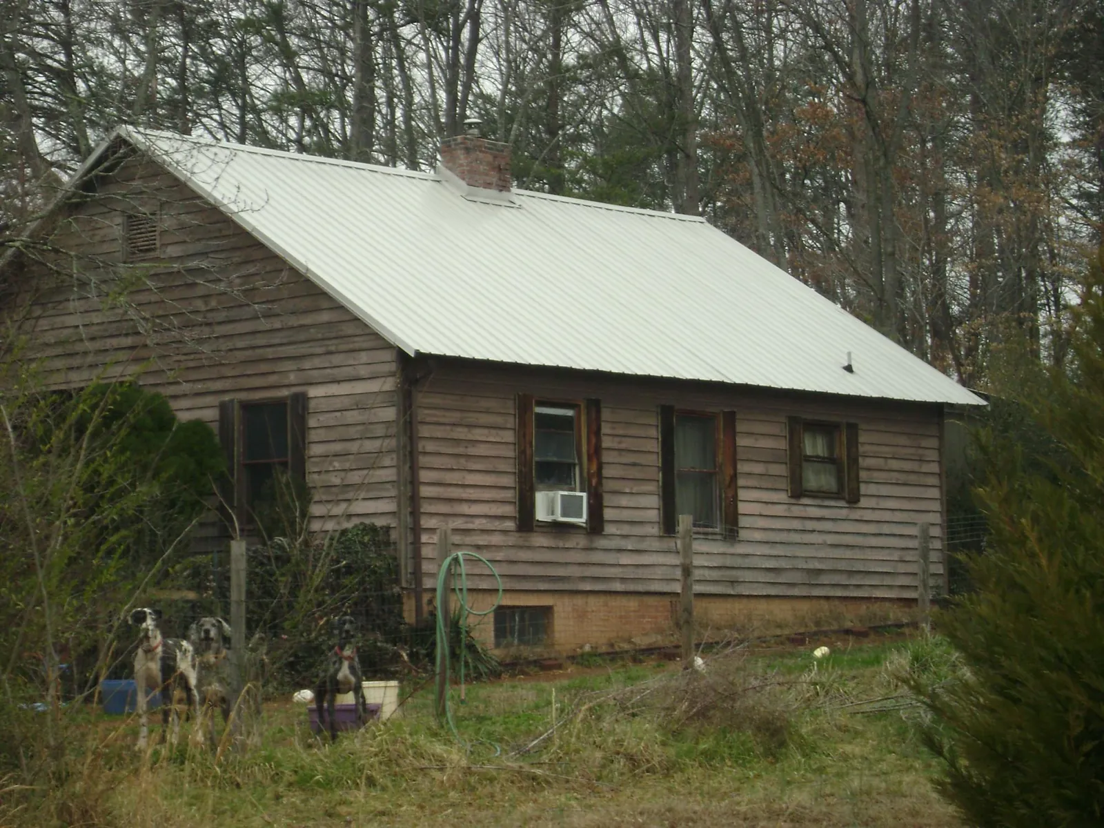 White metal roof on an old wood sided farmhouse, from a Metal Roof Installation job in Kenansville